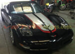 Black C5 Corvette with silver and red CE commemorative stripes with jake option