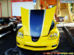 Yellow C6 Corvette convertible with black carbon fiber and silver ME stripe