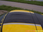Yellow C6 Corvette coupe with black and silver ME stripe