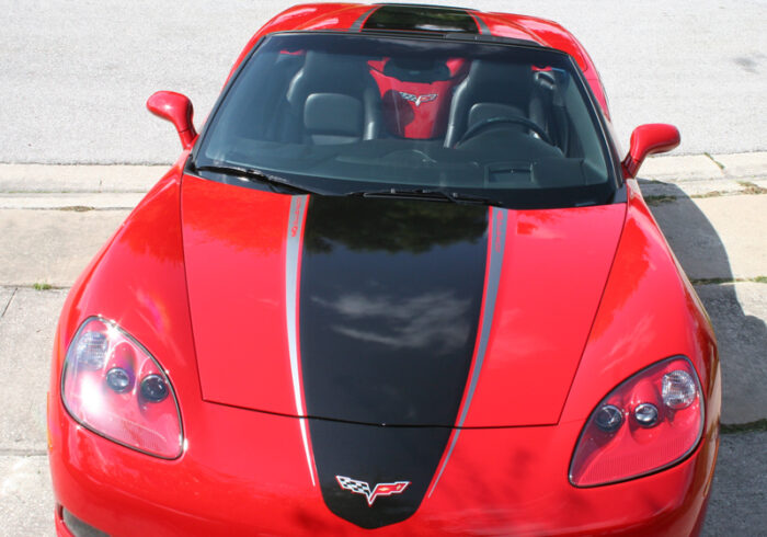Red C6 Corvette with metallic black and gunmetal ME stripes