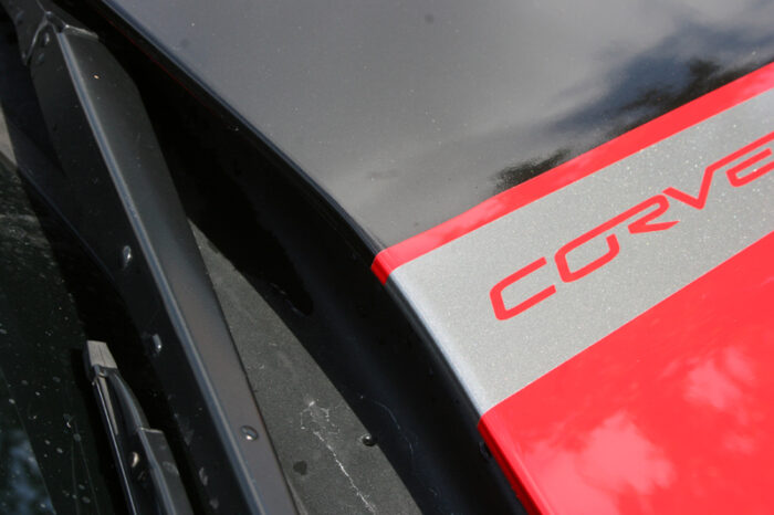 Red C6 Corvette with metallic black and gunmetal ME stripes