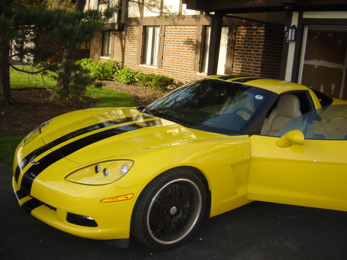 Yellow C6 Corvette with black racing stripe