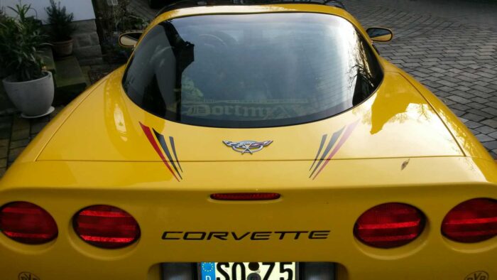 Yellow C5 Corvette with black checker super hood stripe