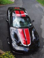 Black C5 Corvette with red and silver CE commemorative stripes