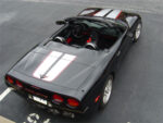 Black C5 Corvette with silver and red CE commemorative stripes
