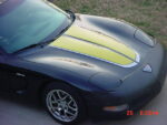 Black C5 Corvette with yellow and silver CE commemorative stripes