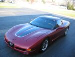 Magnetic red C5 Corvette with gunmetal and silver CE commemorative stripes