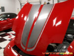 Torch red C5 Corvette with gunmetal and silver CE commemorative stripes