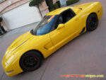 Yellow C5 Corvette with black hood spear stripe