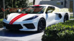 White C8 Corvette Stingray coupe with GM full length dual racing stripes 2 in torch red and carbon flash